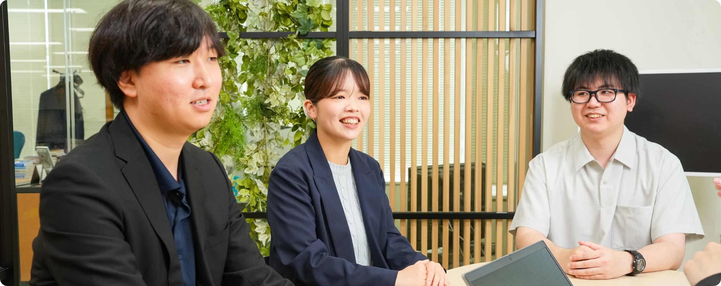 新卒入社から2年目を迎えた3名が談笑する様子